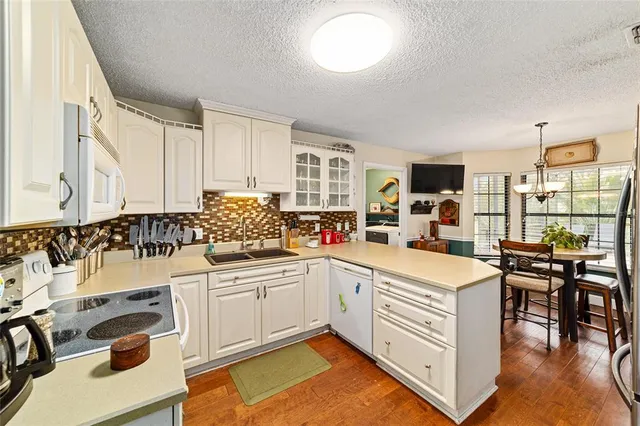a kitchen with a sink stove and cabinets