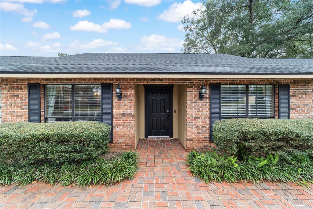 5030 Southeast 3rd Place Ocala, FL 34471 - Photo 2 of 45 front view of a brick house with large windows