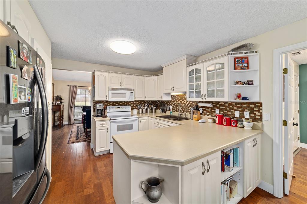 5030 Southeast 3rd Place Ocala, FL 34471 - Photo 22 of 45 a kitchen with a sink a stove and chairs