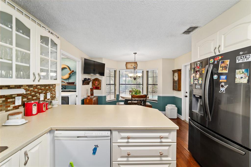 5030 Southeast 3rd Place Ocala, FL 34471 - Photo 23 of 45 a kitchen with a refrigerator and a stove top oven