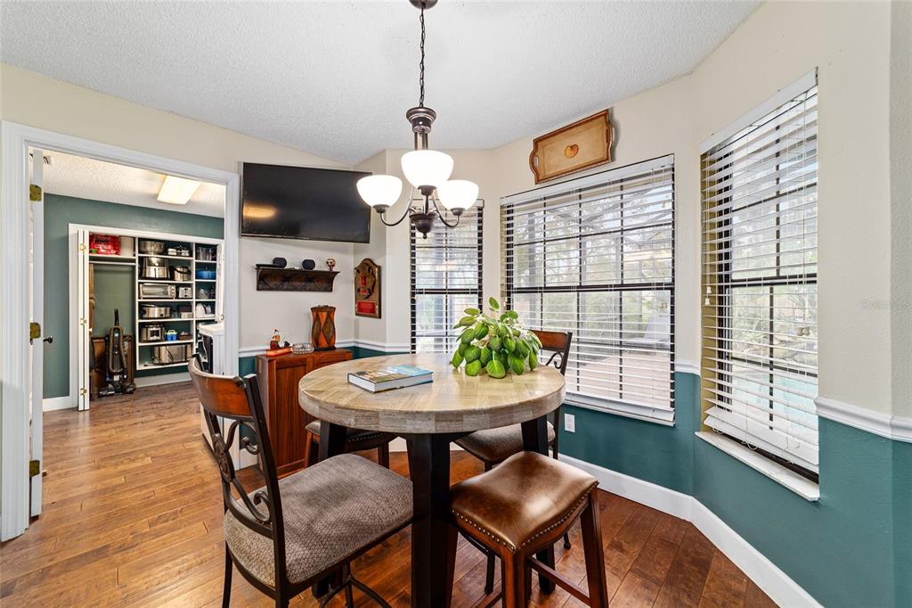 5030 Southeast 3rd Place Ocala, FL 34471 - Photo 24 of 45 a dining room with furniture a window and wooden floor