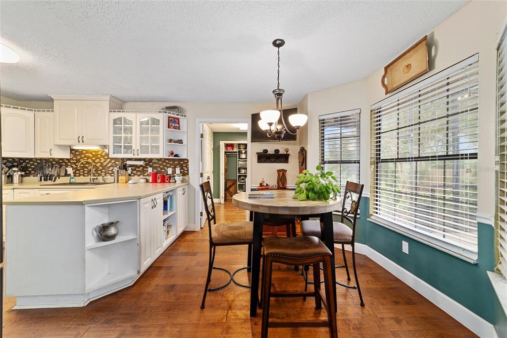 5030 Southeast 3rd Place Ocala, FL 34471 - Photo 25 of 45 a kitchen with stainless steel appliances kitchen island granite countertop a table chairs and a wooden floor