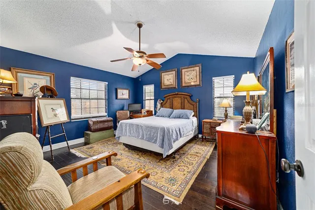 a bedroom with a bed a couch and dresser