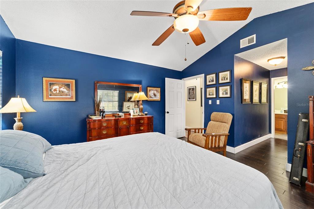 5030 Southeast 3rd Place Ocala, FL 34471 - Photo 30 of 45 a bedroom with a bed and a chandelier