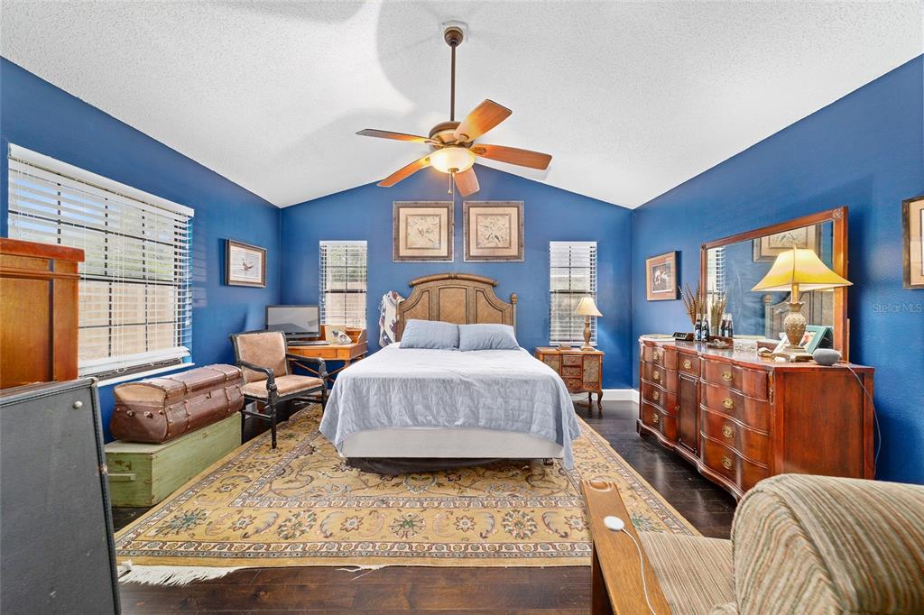 5030 Southeast 3rd Place Ocala, FL 34471 - Photo 31 of 45 a bedroom with a bed and wooden floor