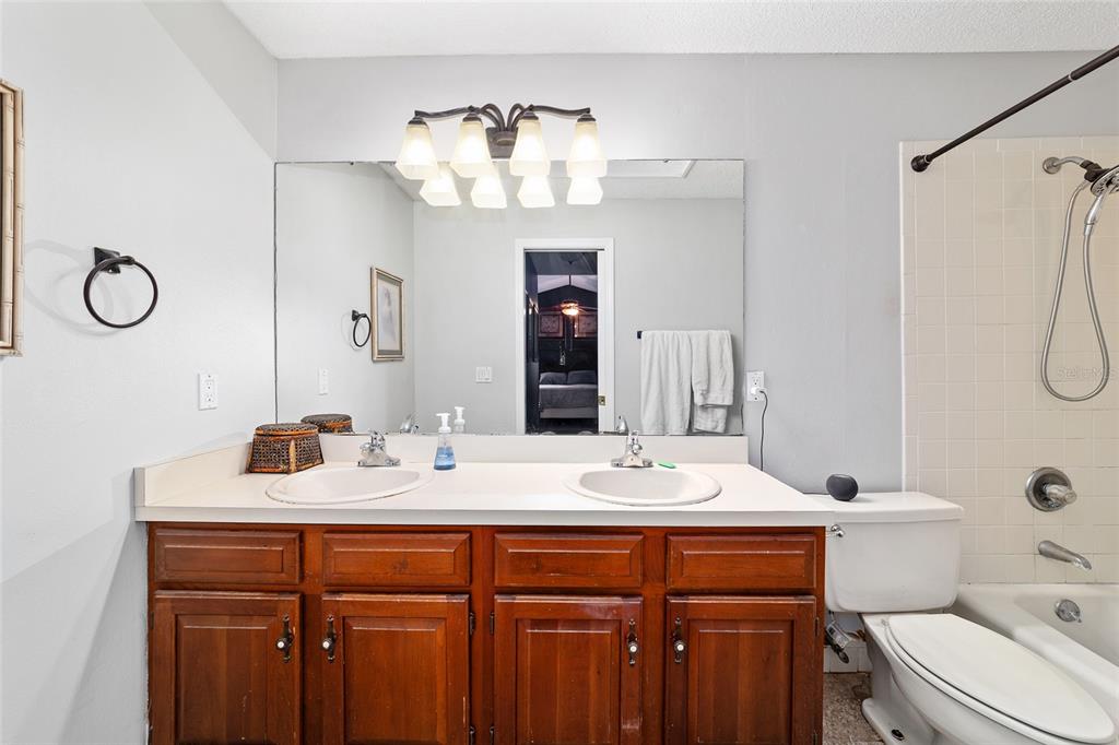 5030 Southeast 3rd Place Ocala, FL 34471 - Photo 32 of 45 a bathroom with a sink vanity granite toilet and a mirror