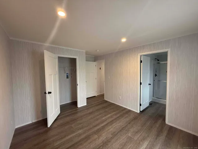 a view of a hallway with wooden floor