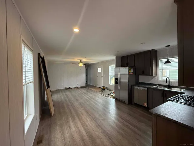 a kitchen with a refrigerator and a stove top oven