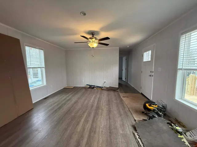 wooden floor in an empty room with a window