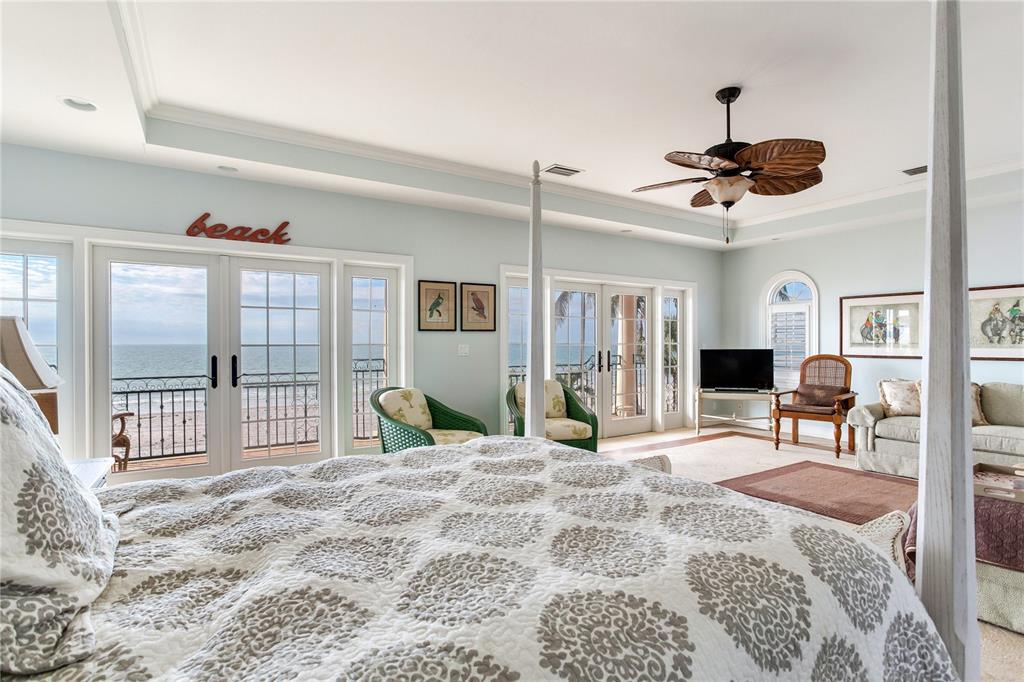 16116 Gulf Boulevard Redington Beach, FL 33708 - Photo 11 of 49 a bedroom with a bed a large window with table and chairs