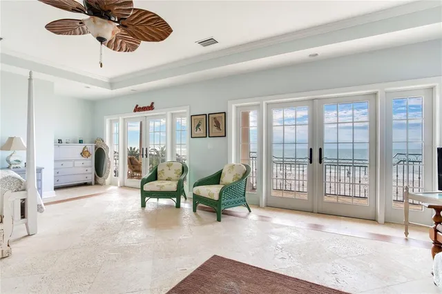 a living room with furniture and a floor to ceiling window