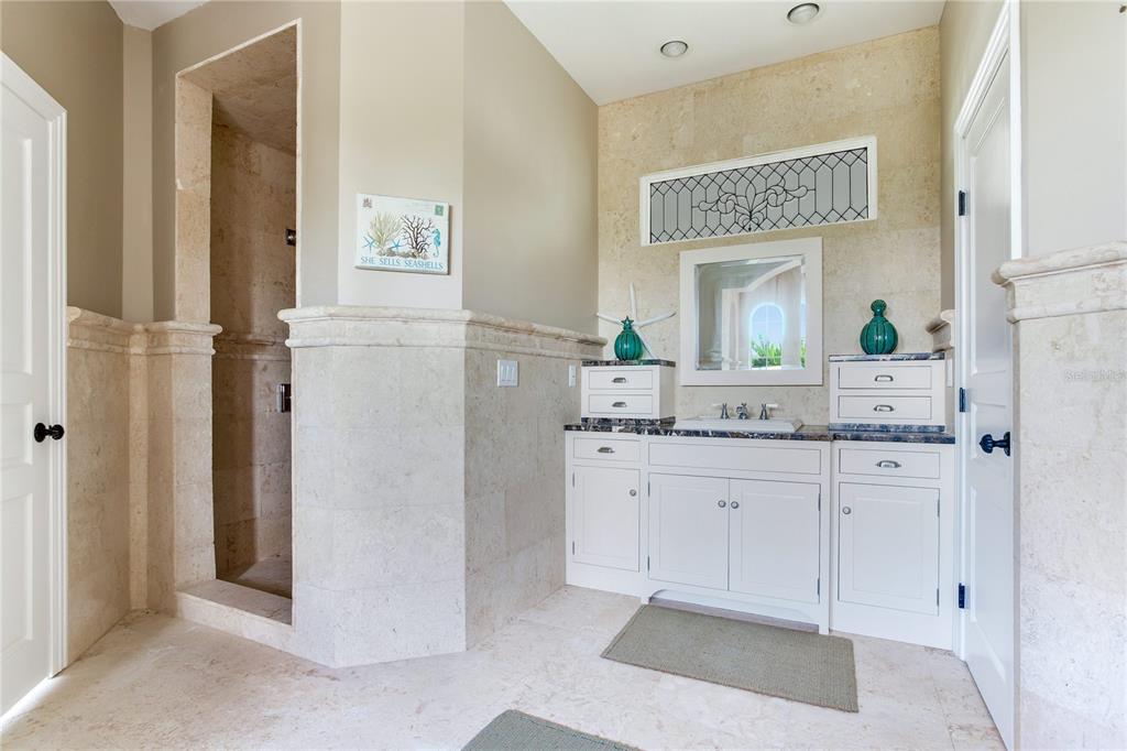 16116 Gulf Boulevard Redington Beach, FL 33708 - Photo 24 of 49 a bathroom with a granite countertop sink mirror and vanity