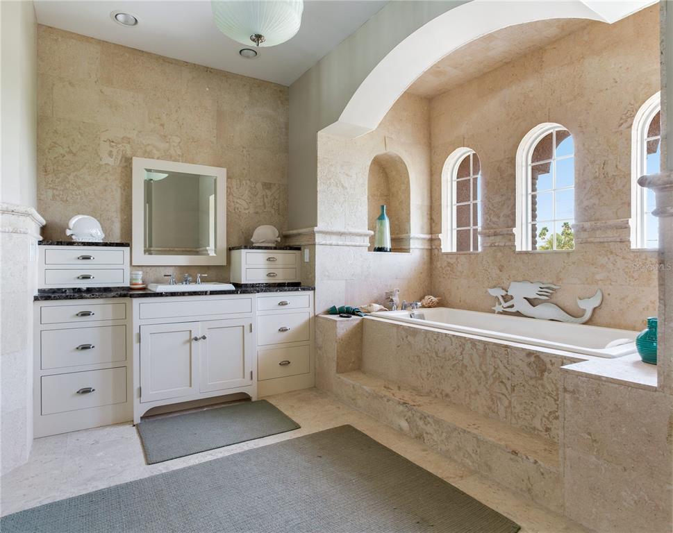 16116 Gulf Boulevard Redington Beach, FL 33708 - Photo 25 of 49 a spacious bathroom with stainless steel appliances a sink and a large mirror