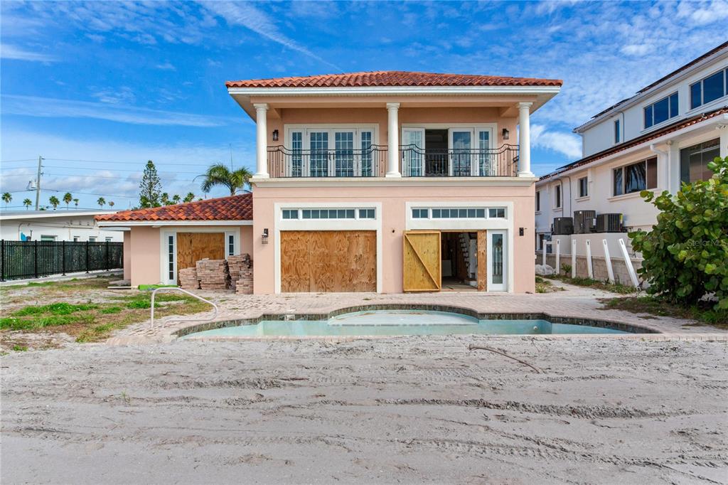 16116 Gulf Boulevard Redington Beach, FL 33708 - Photo 28 of 49 a front view of a house with a yard and garage