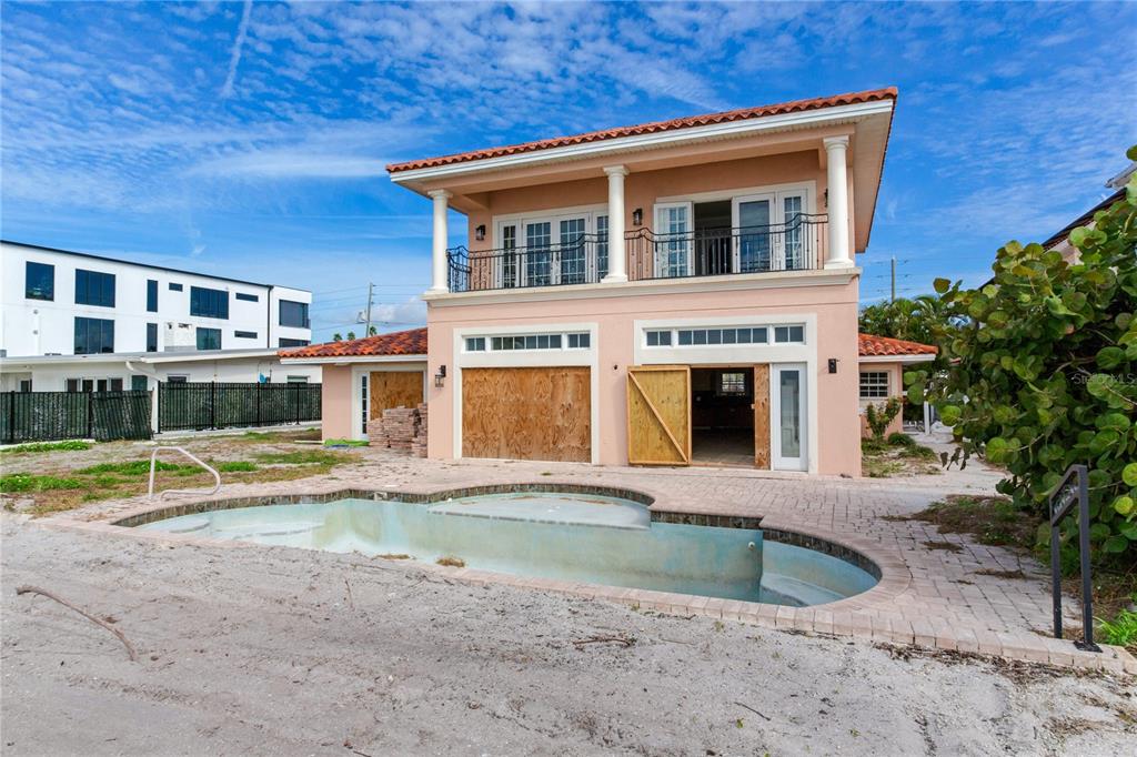 16116 Gulf Boulevard Redington Beach, FL 33708 - Photo 29 of 49 a front view of a house with swimming pool