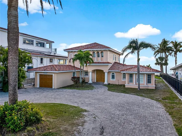 a view of a house with a yard and potted plants