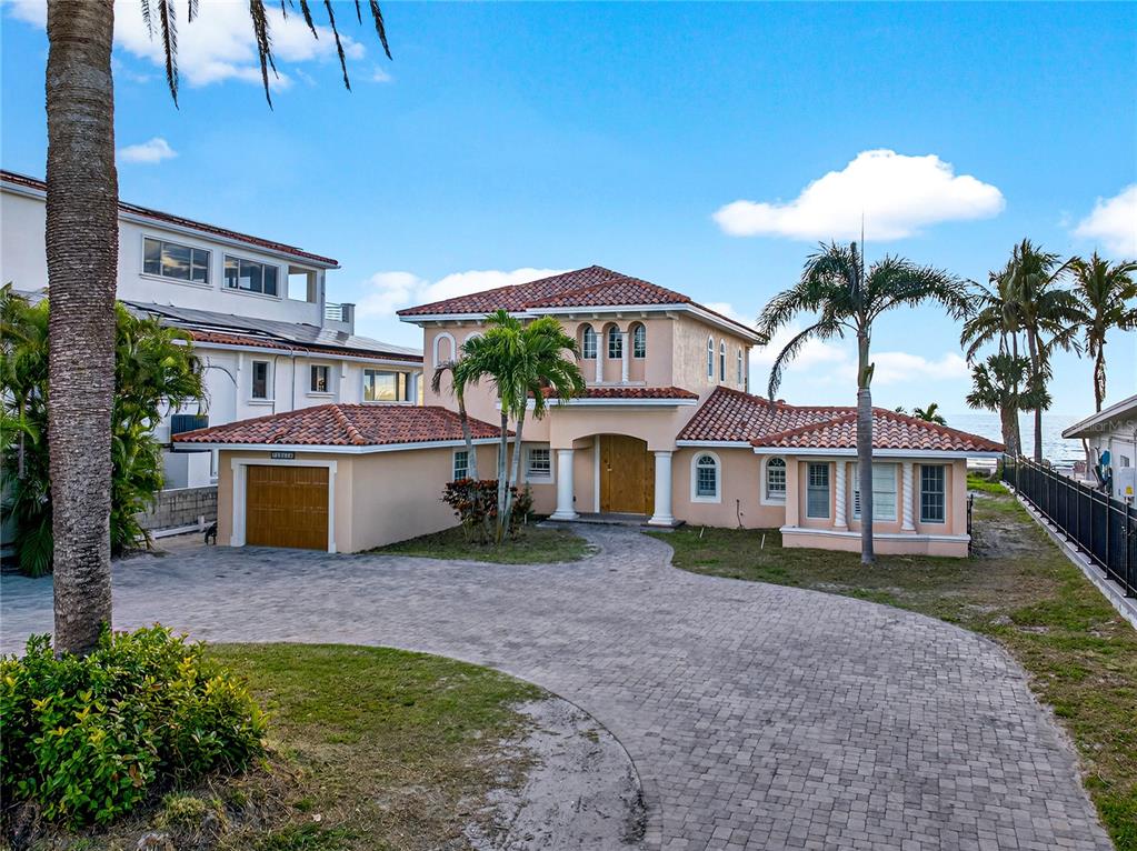 16116 Gulf Boulevard Redington Beach, FL 33708 - Photo 48 of 49 a front view of a house with a yard and garage
