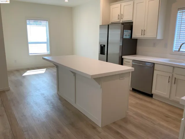 a utility room with cabinets washer and dryer