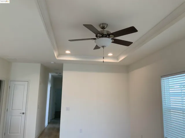 a view of a hallway with a ceiling fan