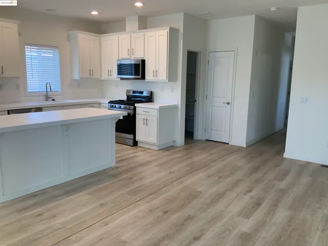 a kitchen with a sink cabinets and a window