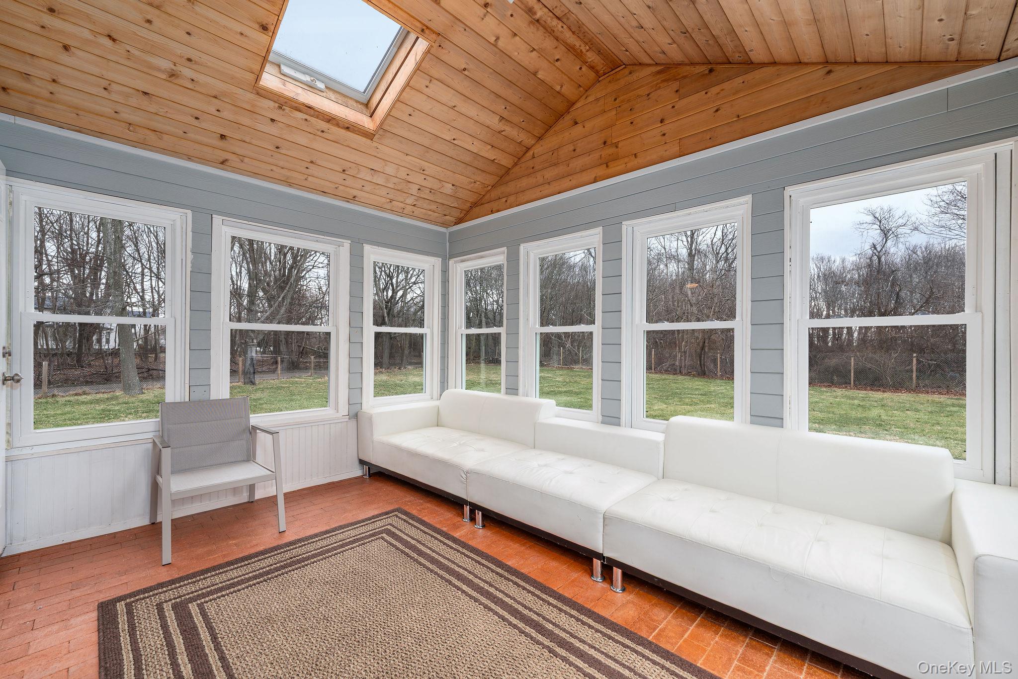 10940 Main Road East Marion, NY 11939 - Photo 12 of 30 a living room with furniture and a large window