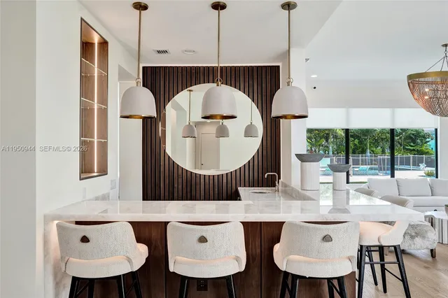 a kitchen with a sink a mirror and cabinets