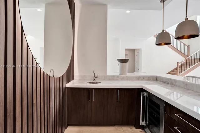 a dining room with wooden floor a chandelier a wooden table and chairs