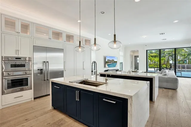 a kitchen with stainless steel appliances a stove sink and cabinets