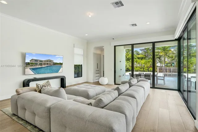 a kitchen with stainless steel appliances a dining table chairs and sink