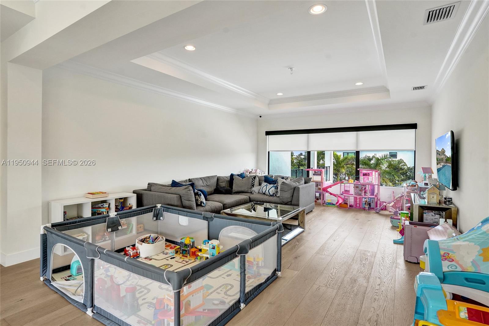 17385 Ponte Chiasso Drive Boca Raton, FL 33496 - Photo 34 of 38 a living room with furniture and a flat screen tv