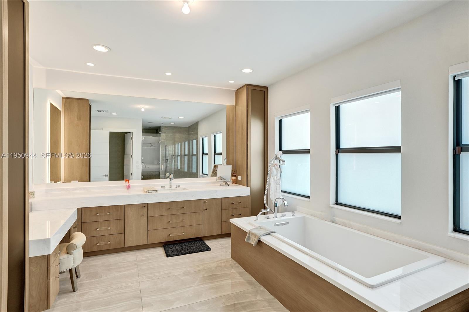 17385 Ponte Chiasso Drive Boca Raton, FL 33496 - Photo 35 of 38 a large bathroom with a large tub and sink