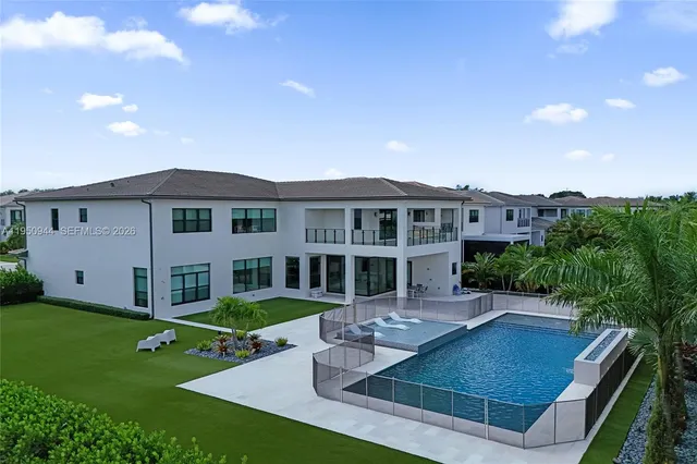 a view of a house with backyard and sitting area