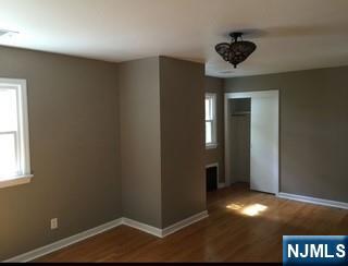 506 Riverside Avenue Rutherford, NJ 07070 - Photo 11 of 12 an empty room with wooden floor and closet