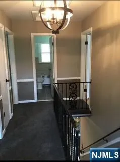 a view of entryway and hall with a front door