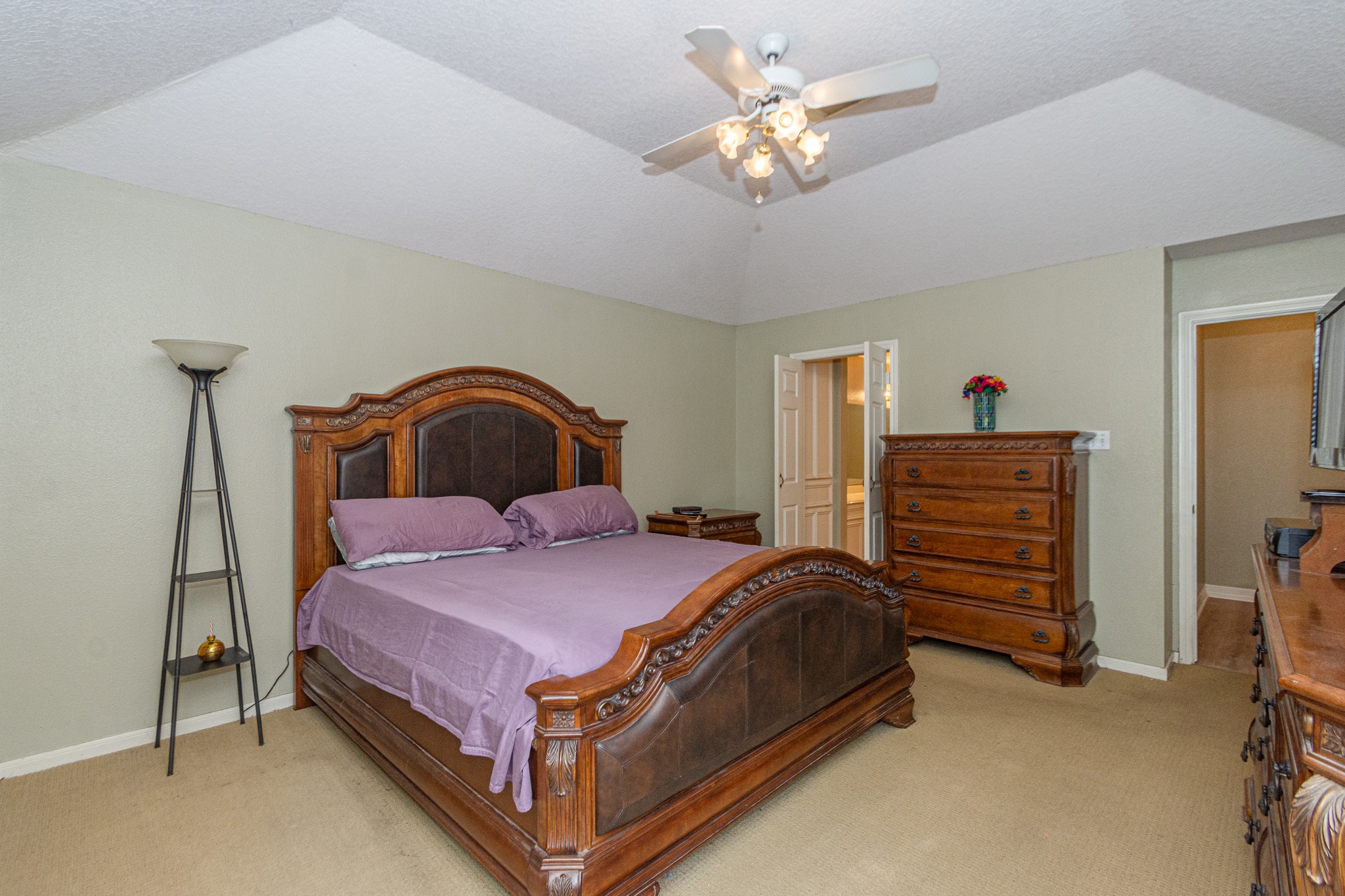 808 Manor Drive Angleton, TX 77515 - Photo 20 of 31 a bedroom with a bed and a chandelier
