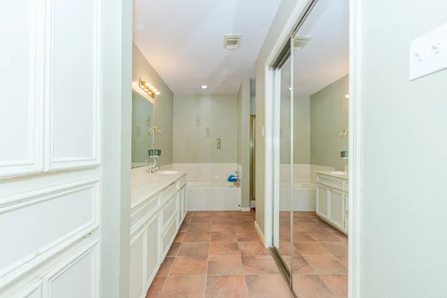 a bathroom with a glass shower door