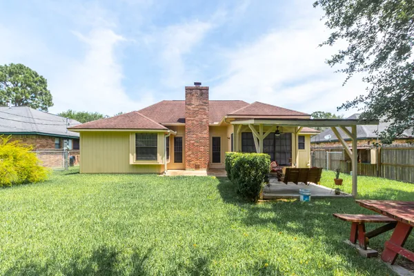 a front view of house with yard and green space