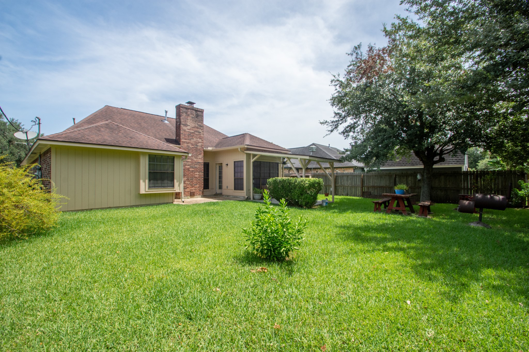 808 Manor Drive Angleton, TX 77515 - Photo 31 of 31 a front view of a house with a garden