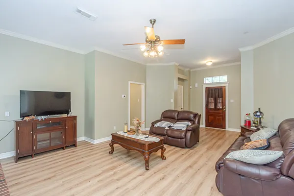 a living room with furniture and a flat screen tv