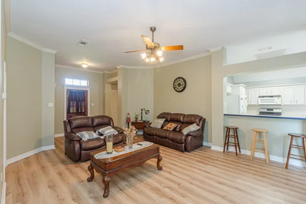 a living room with furniture and a wooden floor