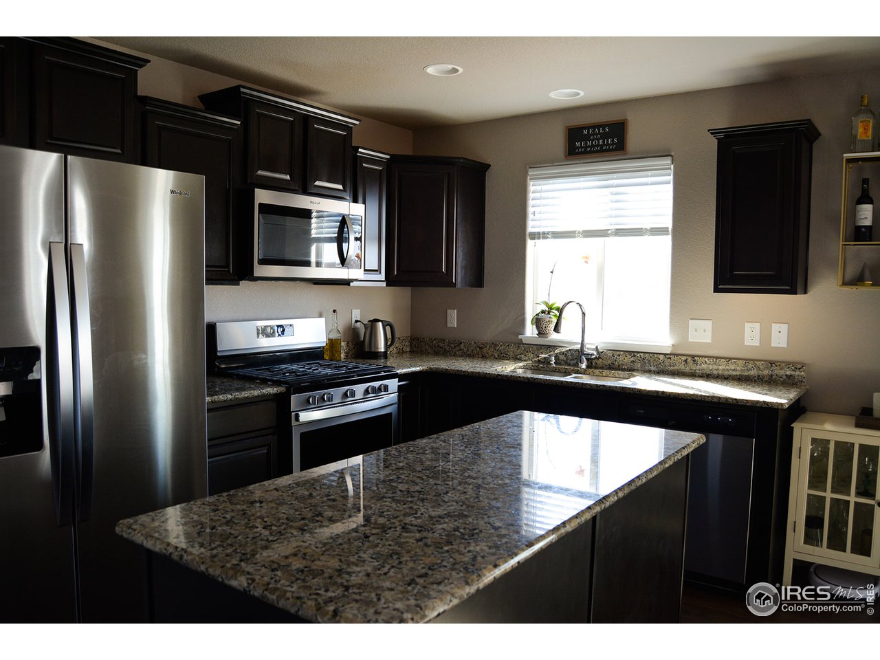 1389 Copeland Falls Road Severance, CO 80550 - Photo 11 of 38 Contemporary kitchen with gas range and under cabinet microwave.