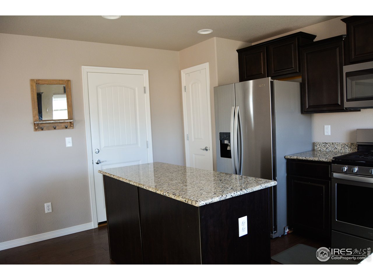 1389 Copeland Falls Road Severance, CO 80550 - Photo 13 of 38 Beautiful cabinets with granite countertops.