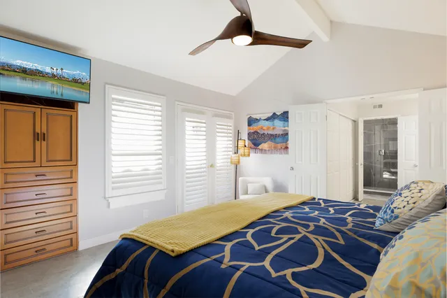 a bedroom with a bed lamp and window