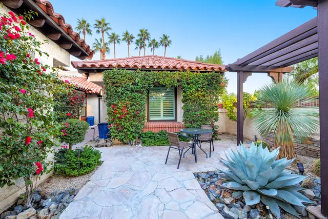 a living room with furniture and floor to ceiling windows