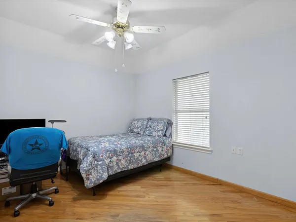 a bedroom with a bed a window and a chandelier