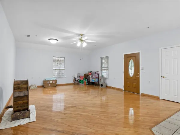 a view of living room with furniture and wooden floor