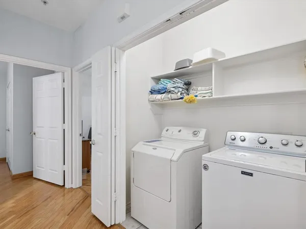 a view of storage and utility room with washer and dryer