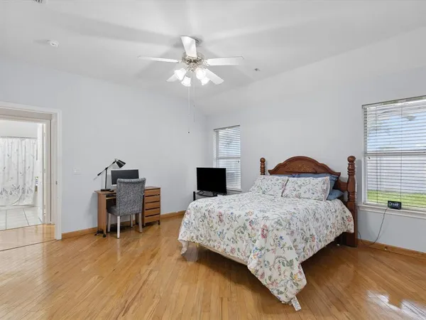 a bedroom with a bed and a table chair