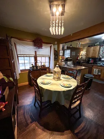 a dining room with furniture and wooden floor