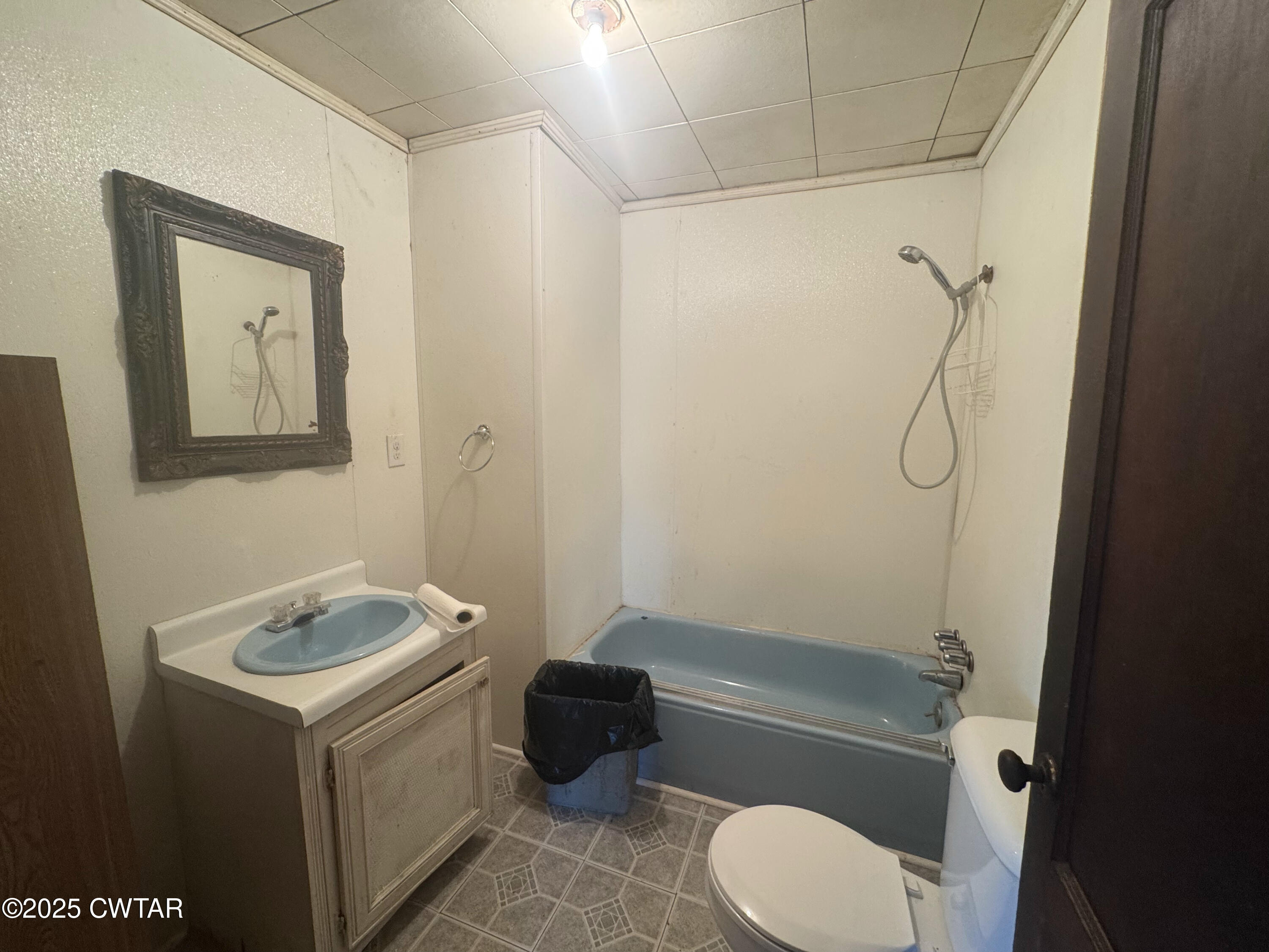 4667 Highway 64 Selmer, TN 38375 - Photo 8 of 10 a bathroom with a granite countertop bathtub shower sink vanity and toilet